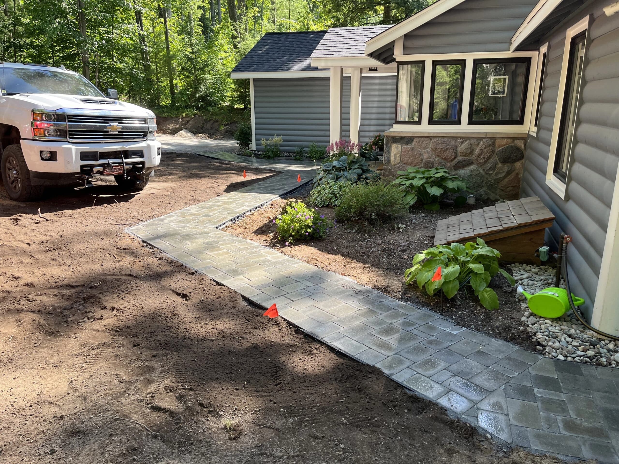 Paver landing and boulder bench overlooking the lake