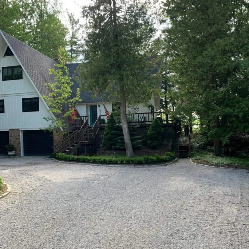 Driveway and landscape clearing along wooded lot